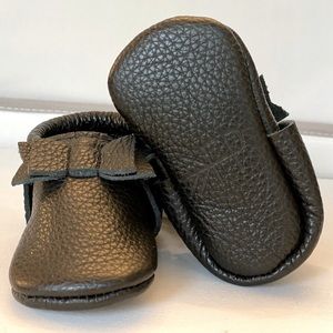 Freshly picked black leather moccasins.
